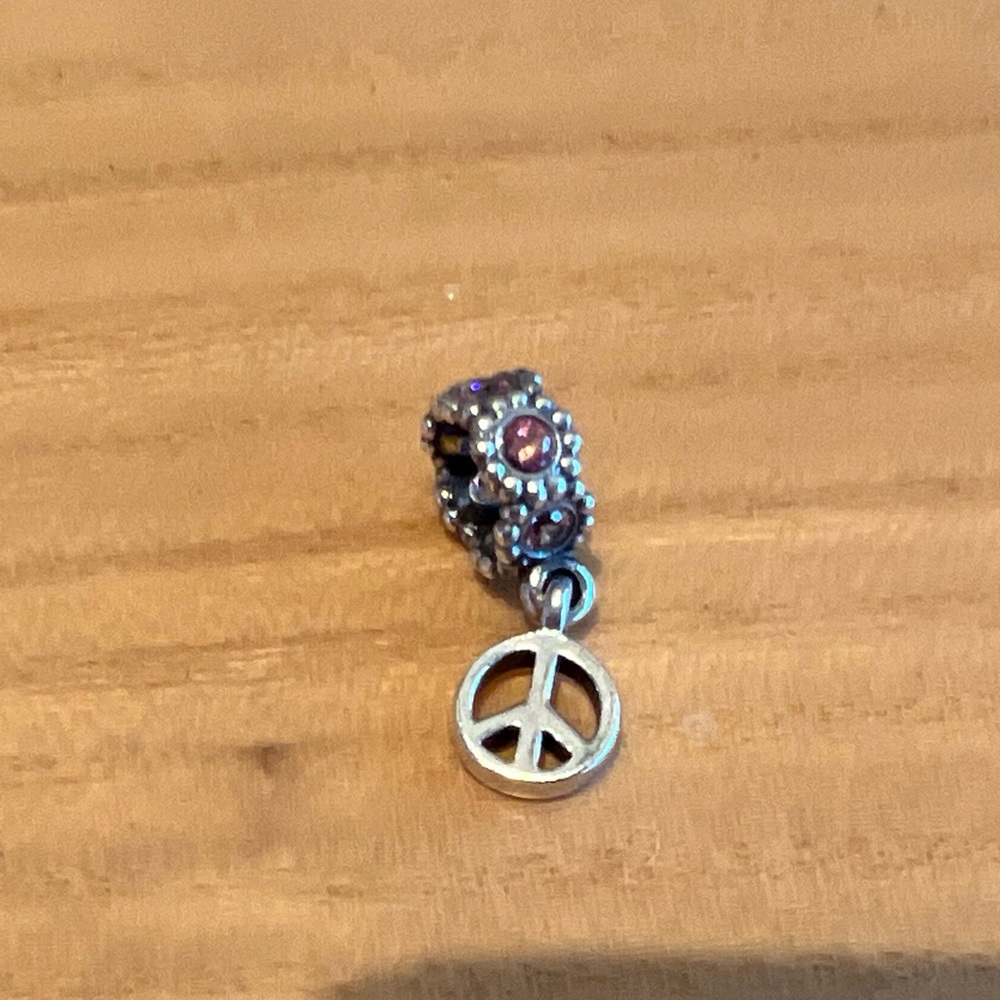 Authentic Pandora silver dangle peace sign charm with pink stones